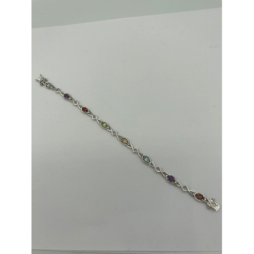 230 - Multi gemstone TENNIS BRACELET having oval cut  TOPAZ, AMETHYST, GARNET, PERIDOT etc, Set and mounte... 