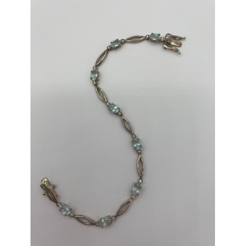 490 - BLUE TOPAZ and SILVER TENNIS BRACELET Having boat shaped silver links with 8  oval cut TOPAZ GEMSTON... 