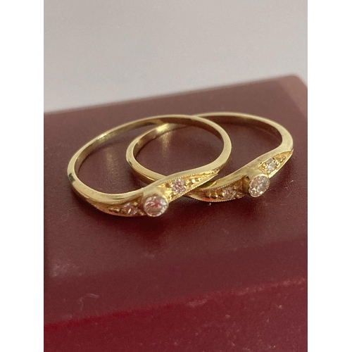 644 - Pair of 14 carat GOLD RINGS worn together in interlocking style. Having sparkling white Gemstones se... 