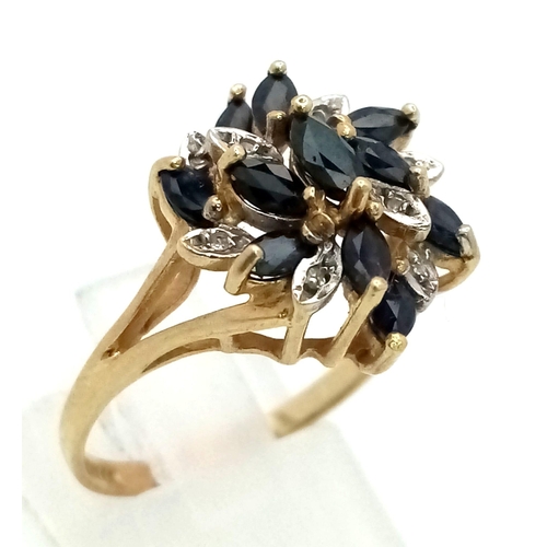 124 - 9K YELLOW GOLD DIAMOND & SAPHIRE CLUSTER RING. TOTAL WEIGHT 3.4G. SIZE P