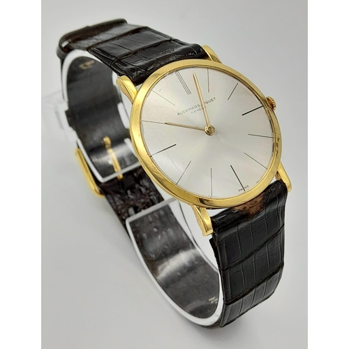 169 - A slim bodied AUDERMARS PIGUET, Geneve watch. Gold tone case 31 mm, silver tone dial, mechanical mov... 