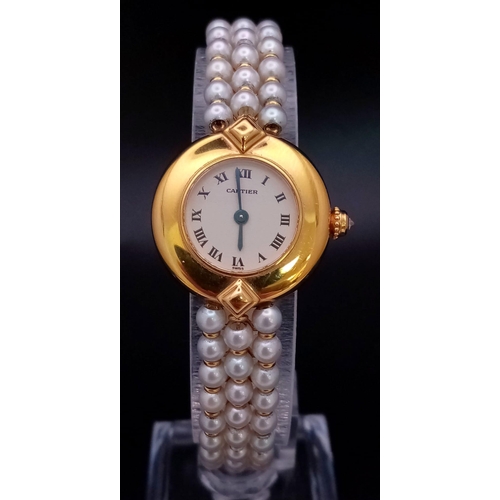 30 - A very feminine CARTIER COLISEE watch. 18 K yellow gold, with a quality genuine pearl strap and a si... 