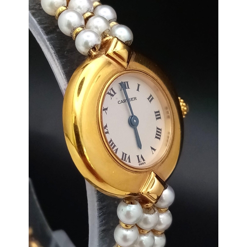 30 - A very feminine CARTIER COLISEE watch. 18 K yellow gold, with a quality genuine pearl strap and a si... 