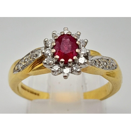 1034 - A Beautiful Vintage 18K Yellow Gold Ruby and Diamond Ring. Central ruby with a diamond halo and a wa... 