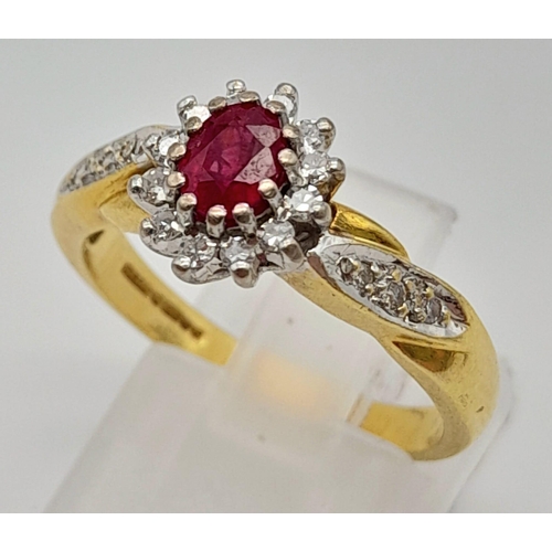 1034 - A Beautiful Vintage 18K Yellow Gold Ruby and Diamond Ring. Central ruby with a diamond halo and a wa... 