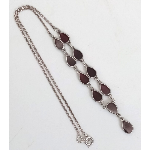 1146 - A Silver Garnet Cabochon Necklace. 40cm