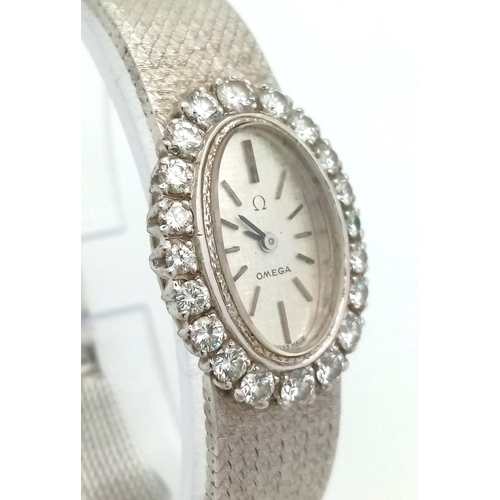 260 - An 18 K white gold OMEGA ladies watch. case: 25 x 17 mm, bezel with round cut diamonds, mechanical m... 