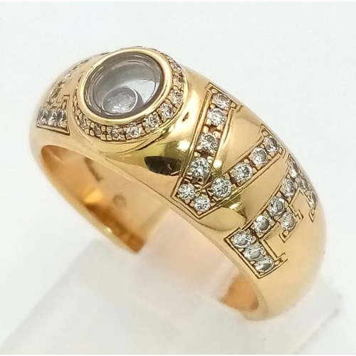 309 - An 18 K yellow gold CHOPPARD ring with diamonds forming the word LOVE  and a floating diamond inside... 