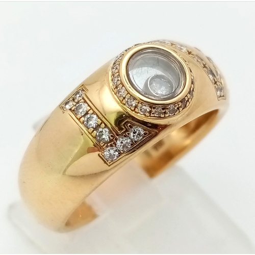 309 - An 18 K yellow gold CHOPPARD ring with diamonds forming the word LOVE  and a floating diamond inside... 