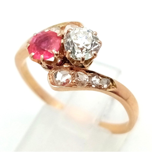 401 - A 14 K yellow gold ring two large stones (a ruby and a brilliant cut diamond) with more diamonds on ... 