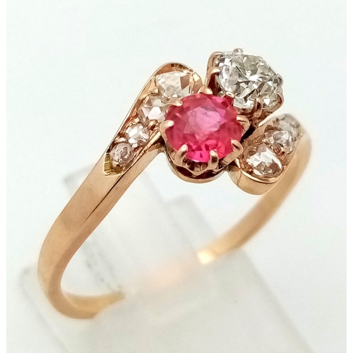 401 - A 14 K yellow gold ring two large stones (a ruby and a brilliant cut diamond) with more diamonds on ... 