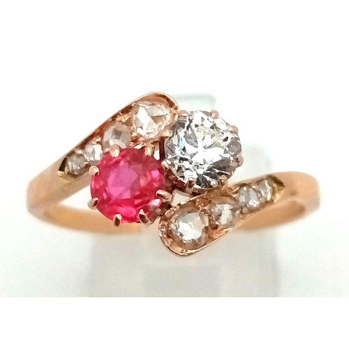 401 - A 14 K yellow gold ring two large stones (a ruby and a brilliant cut diamond) with more diamonds on ... 