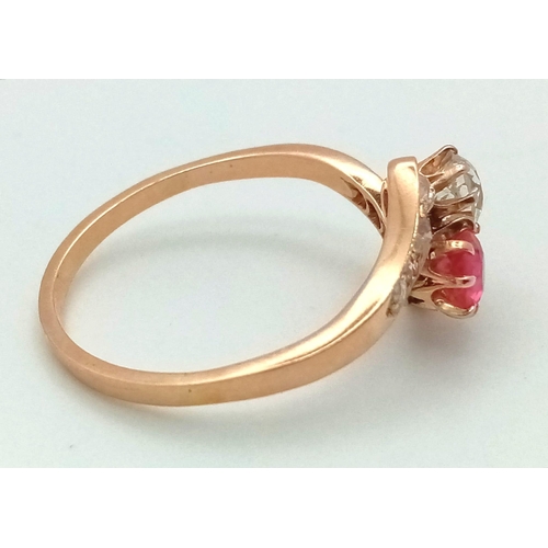 401 - A 14 K yellow gold ring two large stones (a ruby and a brilliant cut diamond) with more diamonds on ... 