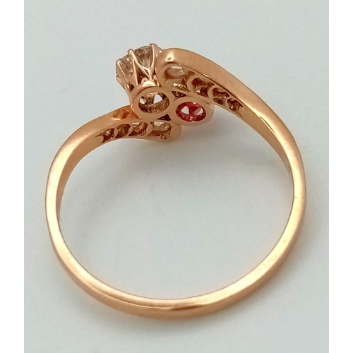 401 - A 14 K yellow gold ring two large stones (a ruby and a brilliant cut diamond) with more diamonds on ... 