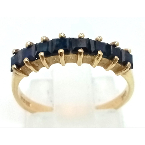 482 - 9K YELLOW GOLD SAPPHIRE SET HALF ETERNITY RING. TOTAL WEIGHT 1.8G. SIZE L