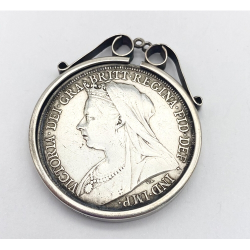 528 - An 1898 Queen Victoria Silver Crown set in a Silver Pendant.
35.37g total weight. Good condition.