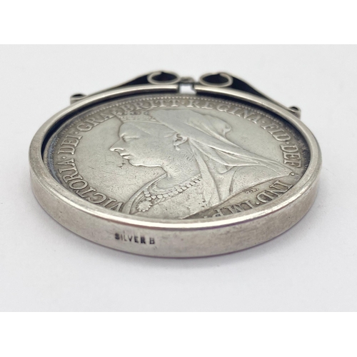 528 - An 1898 Queen Victoria Silver Crown set in a Silver Pendant.
35.37g total weight. Good condition.