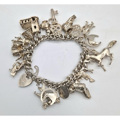 1172 - A 925 Silver Charm Bracelet with an Eclectic Mix of 24 Charms. Including: Stallion, Church-mouse and... 