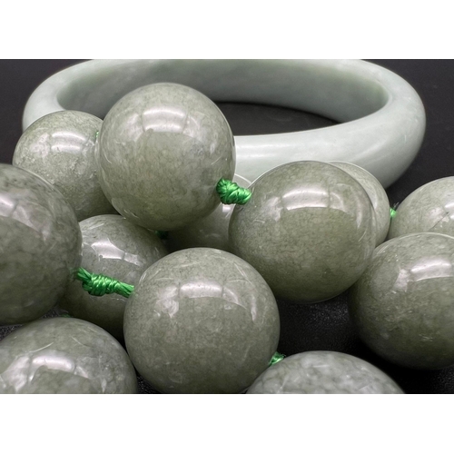 1263 - A Pale Green Jade Bangle and Necklace Bead Set. Beads -14mm. 6cm inner diameter bangle. Necklace len... 