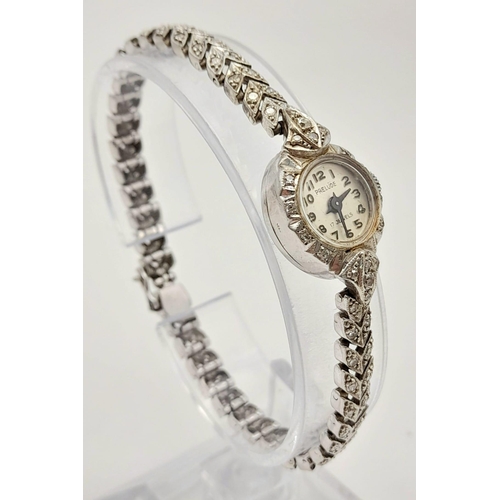 32 - A Vintage 9K White Gold and Diamond Prelude Ladies Watch. 9k white gold and diamond chevron bracelet... 