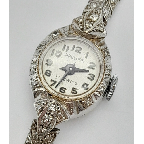 32 - A Vintage 9K White Gold and Diamond Prelude Ladies Watch. 9k white gold and diamond chevron bracelet... 