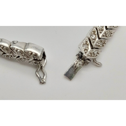 32 - A Vintage 9K White Gold and Diamond Prelude Ladies Watch. 9k white gold and diamond chevron bracelet... 