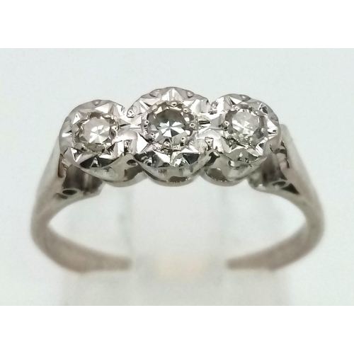 107 - An 18K White Gold Three Stone Diamond Ring. Size N. 3.05g total weight.