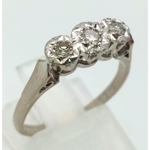 107 - An 18K White Gold Three Stone Diamond Ring. Size N. 3.05g total weight.