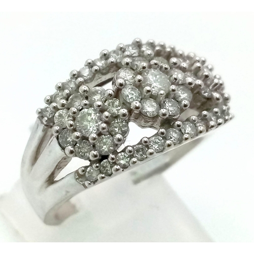 18 - A 14K White Gold Diamond Three Flower Cluster Ring. 0.8ct approx. Size N. 6.61g