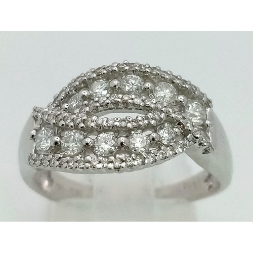 24 - An 18K White Gold and Diamond Cluster Crossover Ring. 0.60ct approx. Size O. 4.8g total weight.