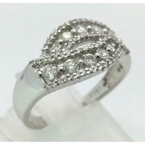 24 - An 18K White Gold and Diamond Cluster Crossover Ring. 0.60ct approx. Size O. 4.8g total weight.