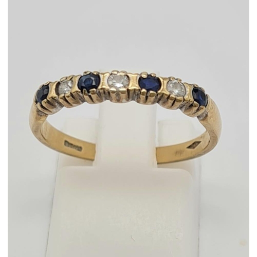 513 - A 9k Yellow Gold Sapphire and White Stone Ring. Size O. 2g total weight.