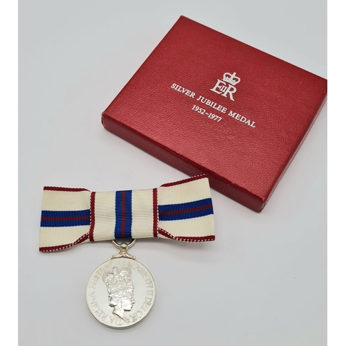 71 - A Queen Elizabeth the Second’s Silver Jubilee Medal 1977, mounted on a ribbon bow for wear by a lady... 