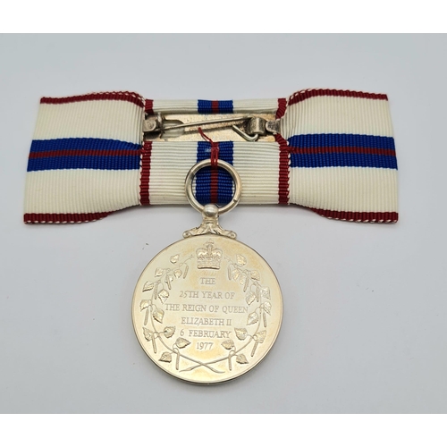 71 - A Queen Elizabeth the Second’s Silver Jubilee Medal 1977, mounted on a ribbon bow for wear by a lady... 