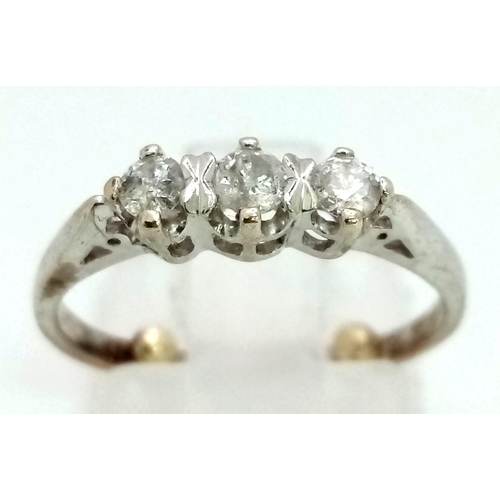 114 - A 9K White Gold Three-Stone Diamond Ring. Size G (adjusted). 1.81g total weight.