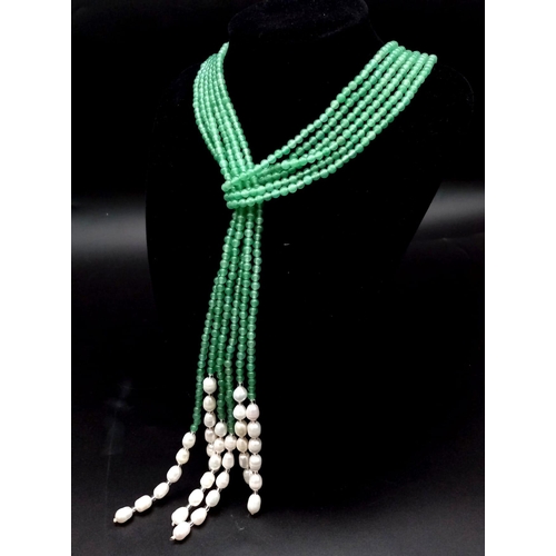 147 - A very feminine, Belle Epoque reminiscent necklace. Three long strands (130 cm) of pale green jade a... 