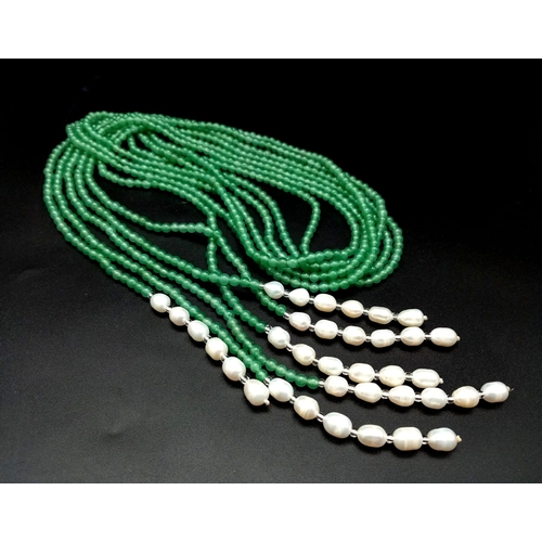 147 - A very feminine, Belle Epoque reminiscent necklace. Three long strands (130 cm) of pale green jade a... 