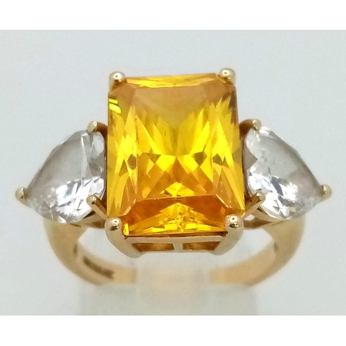 184 - A 14K Yellow Gold Citrine and Moissanite Ring. Large central bright citrine (6ct) with a heart-shape... 