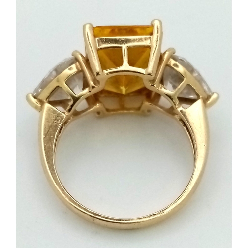 184 - A 14K Yellow Gold Citrine and Moissanite Ring. Large central bright citrine (6ct) with a heart-shape... 