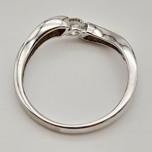 346 - 18k white gold curve ring with tension set cubic zirconia. Total Weight 2.6g, size M.