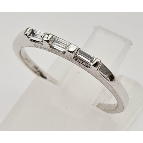 433 - 18K WHITE GOLD 3 STONE DIAMOND BAGUETTE RING. 0.20CT DIAMOND. TOTAL WEIGHT 1.8G SIZE J