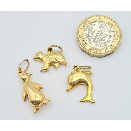 486 - 9k yellow gold penguin (1.2g) dolphin (0.8g) & bear (0.9g) charms total weight 2.9g