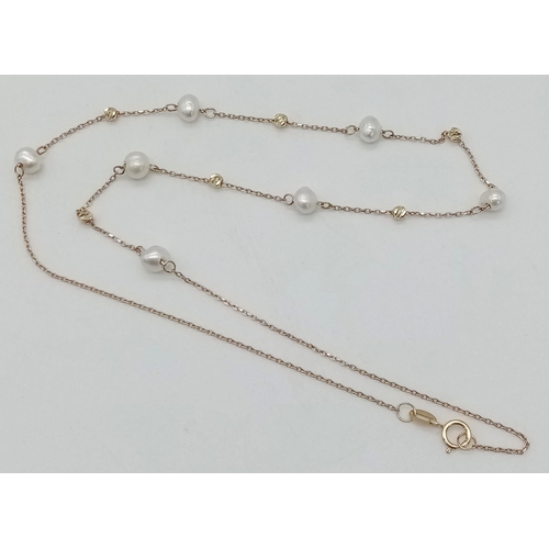 520 - An 18K Yellow Gold and Pearl Necklace. Pearls - 6mm. 2.41g total weight.