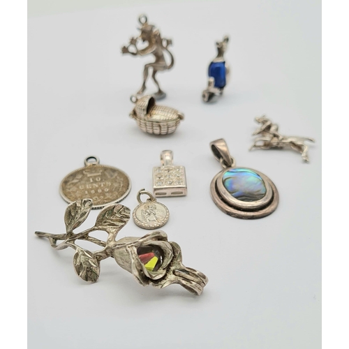 527 - A Small Collection of Nine Silver Charms or Pendants Including: Rose, book, cot, St Christopher, cow... 