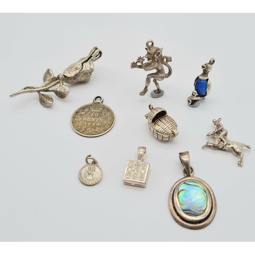 527 - A Small Collection of Nine Silver Charms or Pendants Including: Rose, book, cot, St Christopher, cow... 