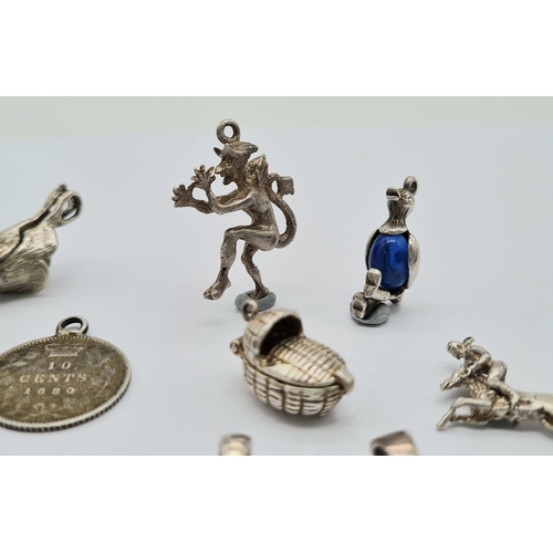 527 - A Small Collection of Nine Silver Charms or Pendants Including: Rose, book, cot, St Christopher, cow... 