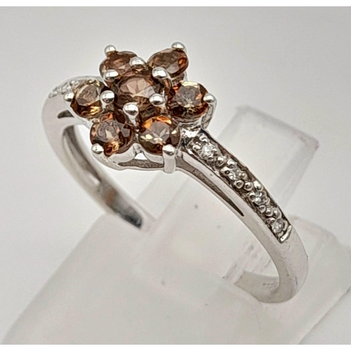 558 - 9K WHITE GOLD DIAMOND 7 BROWN STONE CLUSTER RING. TOTAL WEIGHT 2.5G SIZE N