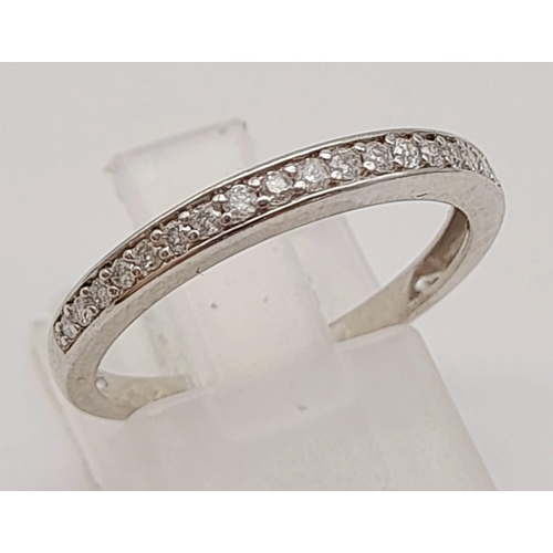 747 - 9K WHITE GOLD DIAMOND HALF ETERNITY RING.  0.16CT DIAMOND. TOTAL WEIGHT 1.7G. SIZE N