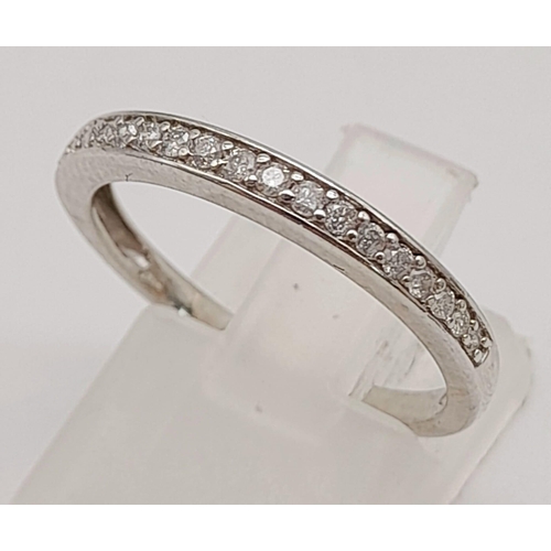 747 - 9K WHITE GOLD DIAMOND HALF ETERNITY RING.  0.16CT DIAMOND. TOTAL WEIGHT 1.7G. SIZE N