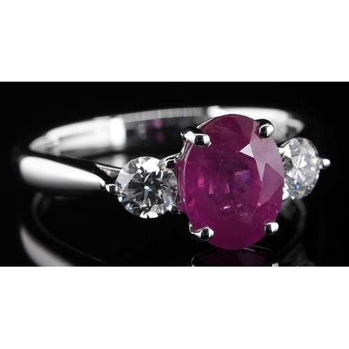 387 - 18k white gold Ruby and Diamond 3 stone ring, 1.85ct oval cut ruby centre, and 0.38ct diamonds to th... 